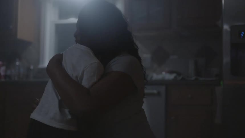 A mother consoles her son