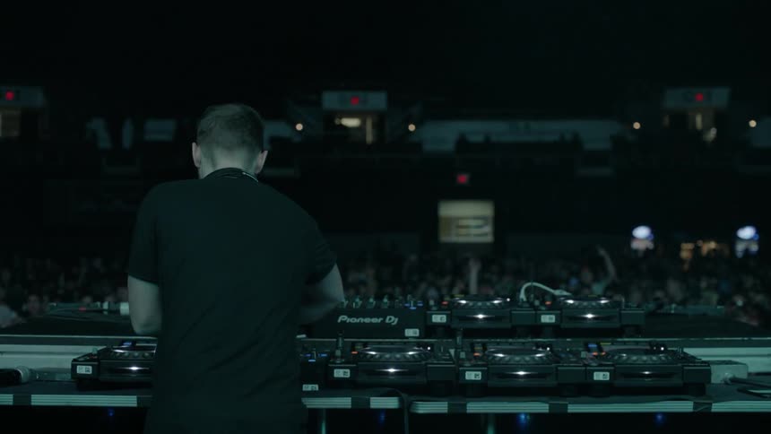 A dj performs for an audience