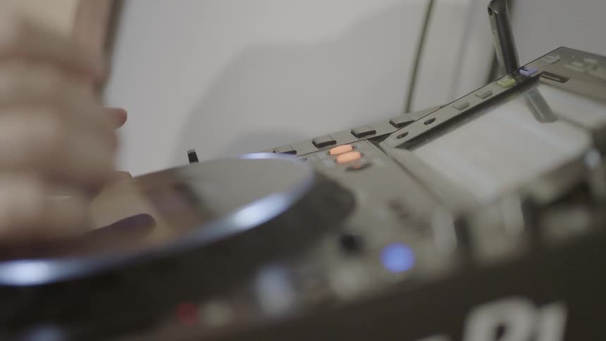 A dj is using a deck to create music
