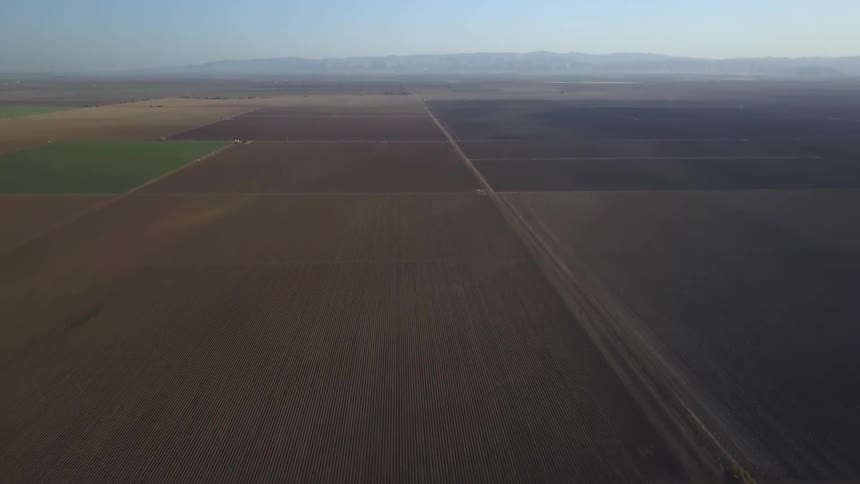 Large fields sit under a blue sky