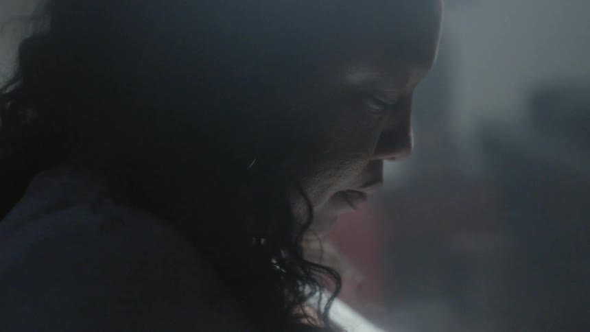 A woman sits and stares down