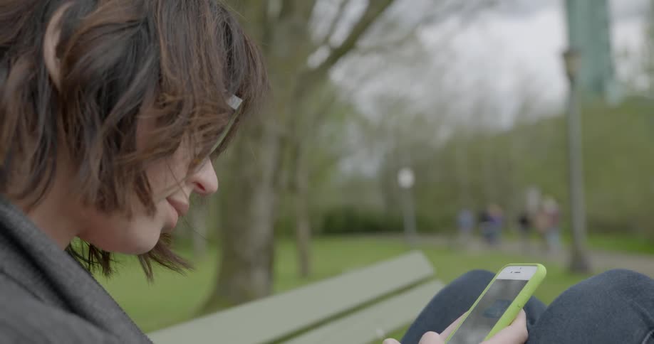 A person using their phone in a park