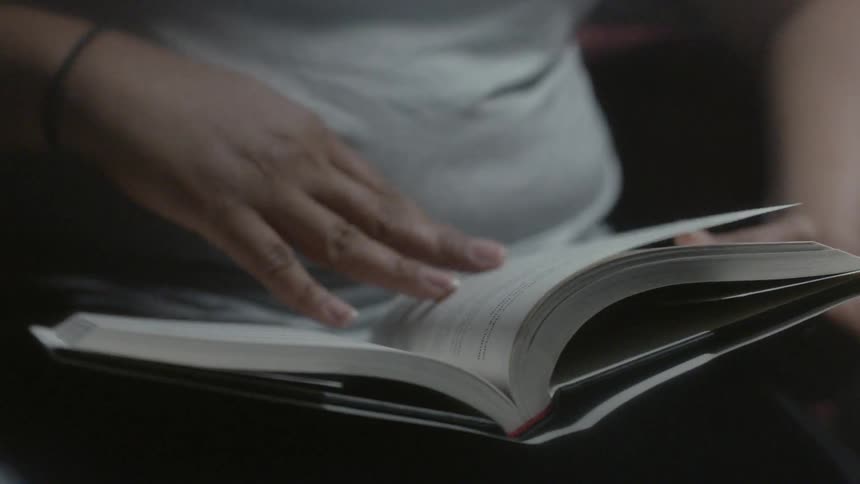 Someone is sitting and reading a book