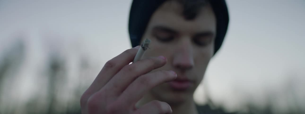 A man is standing and smoking