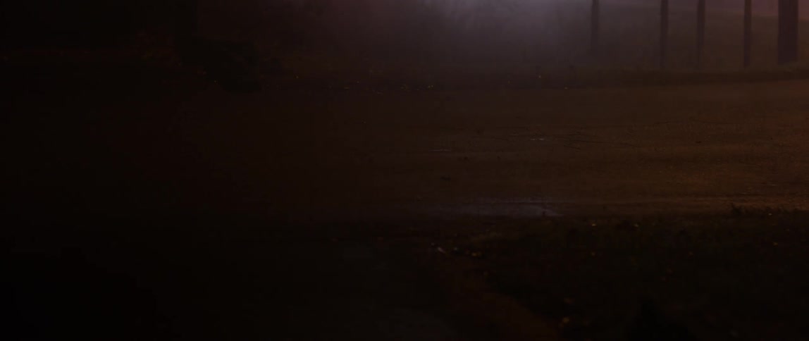 Light briefly illuminates a wet road