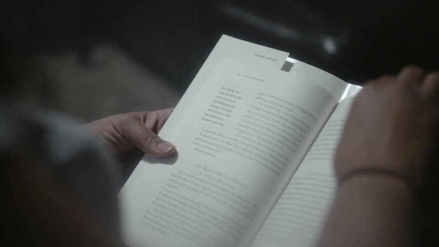 A person flips through a book