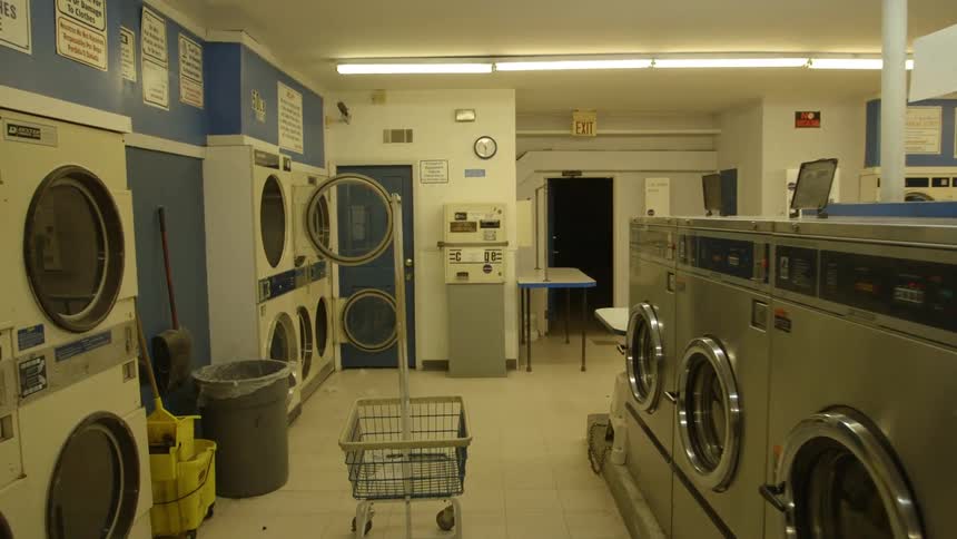 An empty laundromat is shown