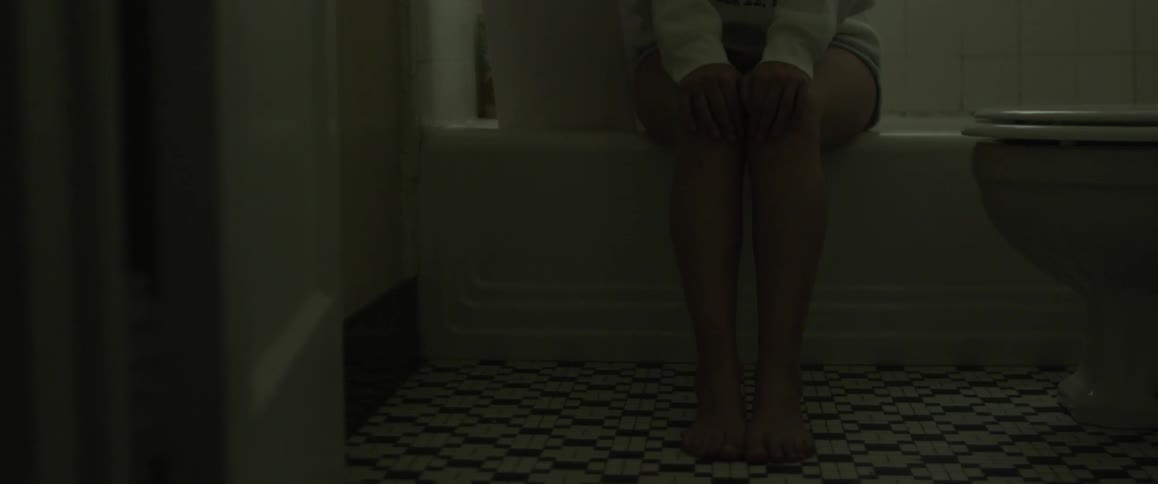 A woman is sitting on a bathtub
