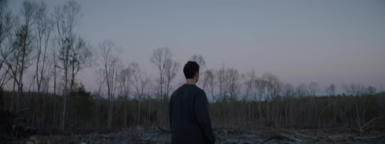 A man walks on the field and removes his mask