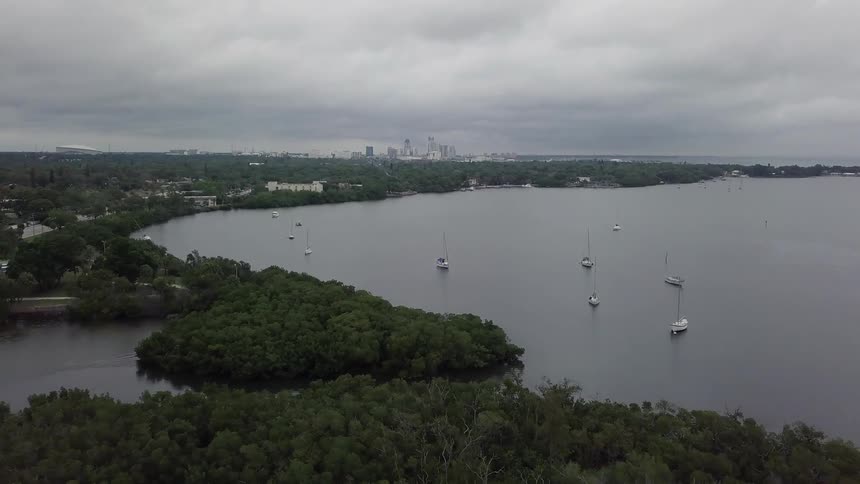 Boats float on the water close to the shore