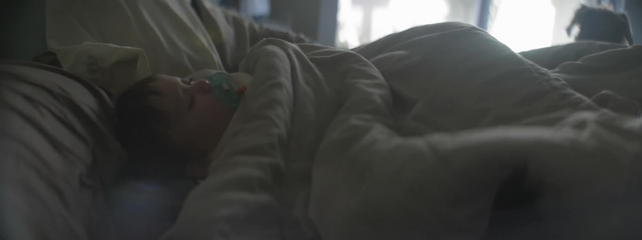 Child sleeping in a large bed