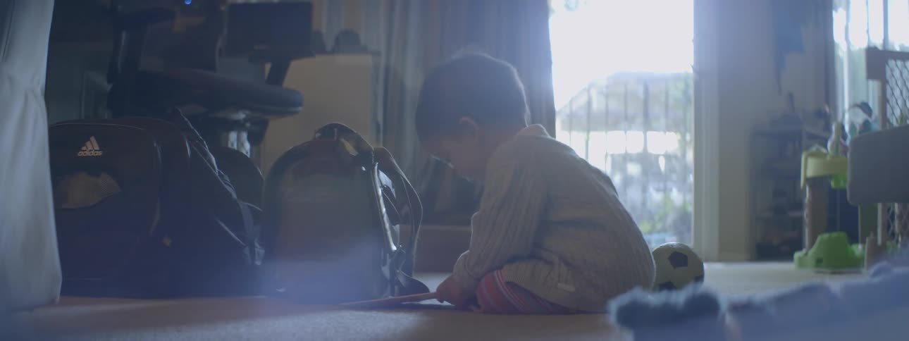 A young infant plays on the carpet