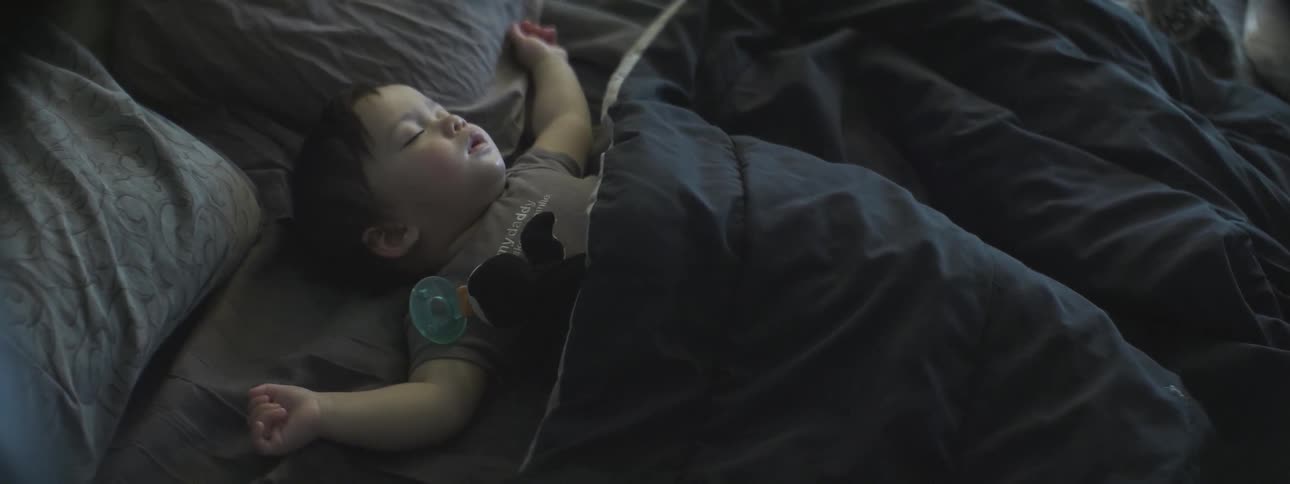A baby is sleeping on a bed