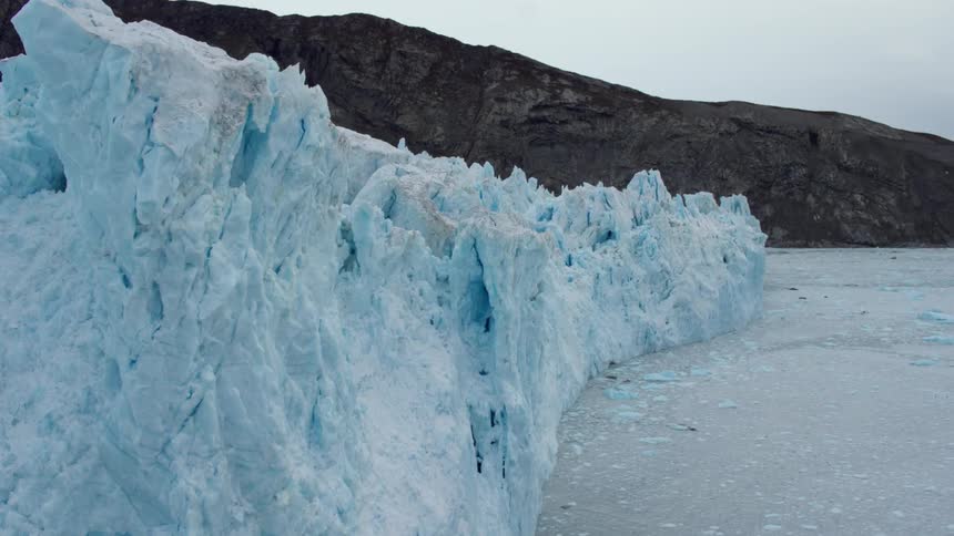 A jagged ice berg forms a wall