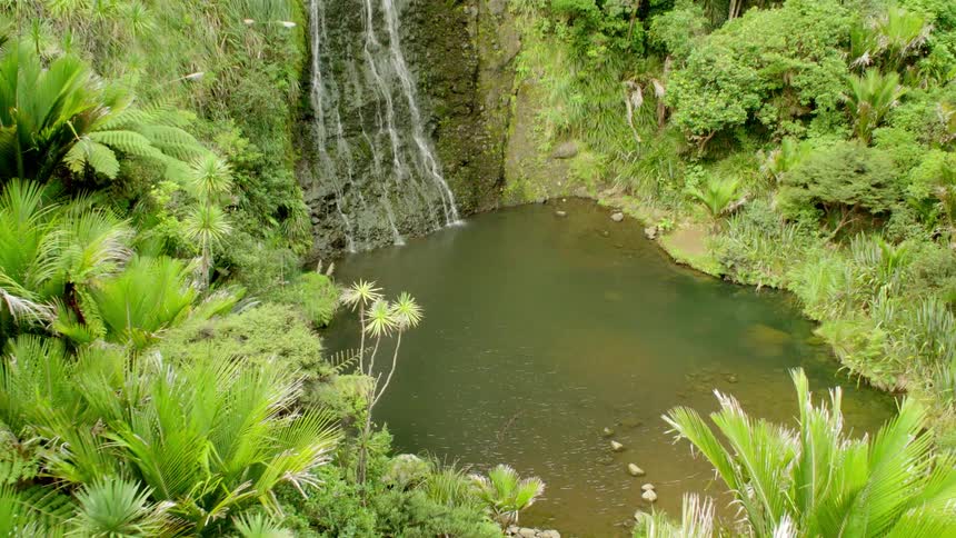 Water falls down a cliff into a ravine