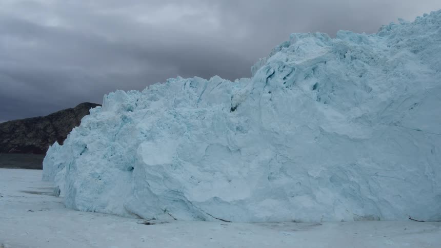 Large pile of snow sits under a cloudy sky
