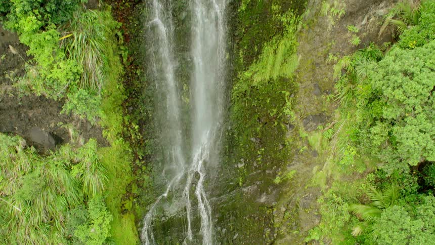 The waterfall is giving a small stream of water down the steep drop