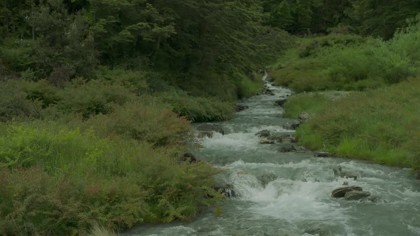 The stream is going fast over the rocks
