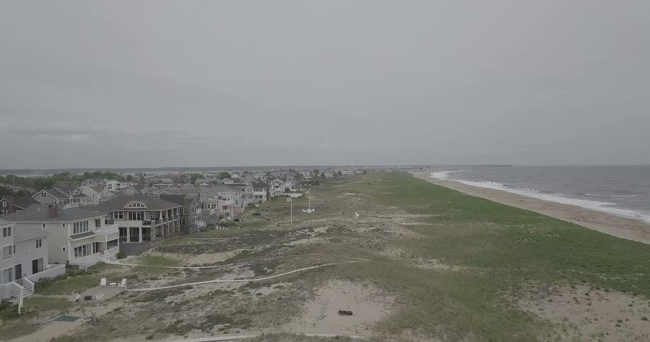 A beach near rows of houses