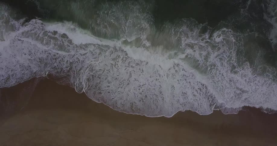 Aerial view of waves splashing to shore
