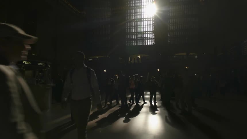 The sun shines through a window in a transportation terminal