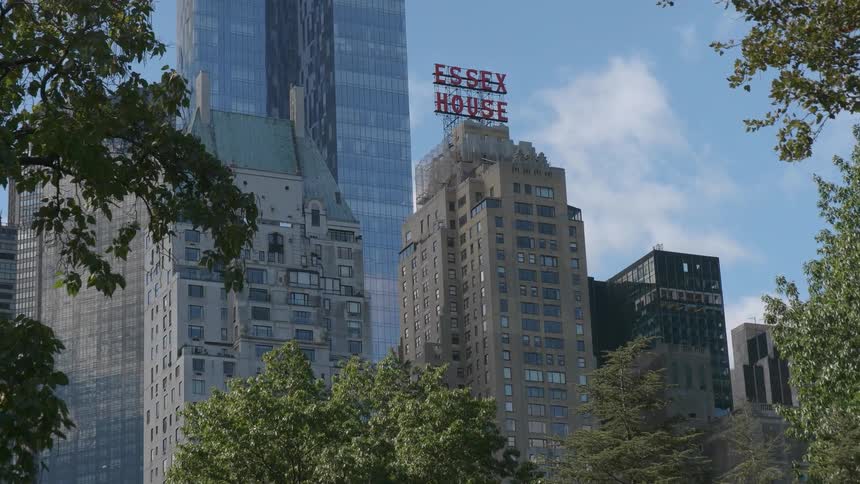 Tall buildings sit under a blue sky