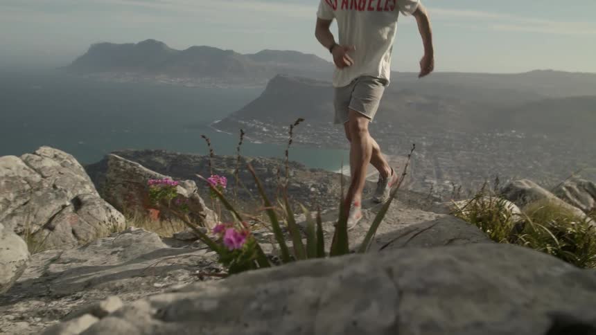 A man jogs up a rocky path