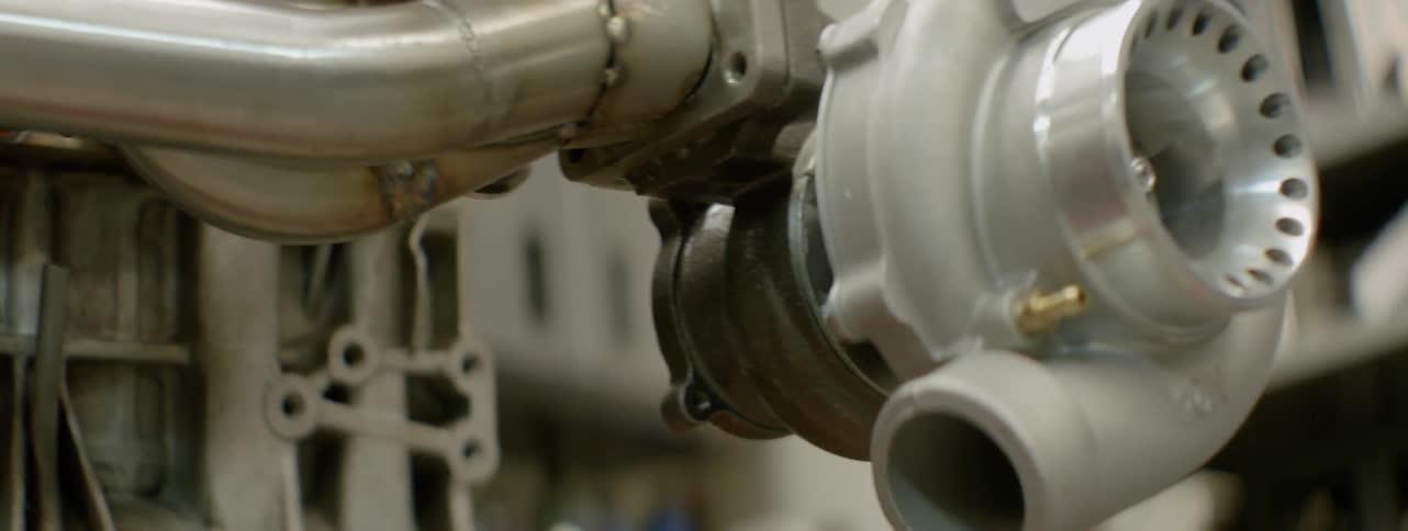 Pipes hang off of engine parts