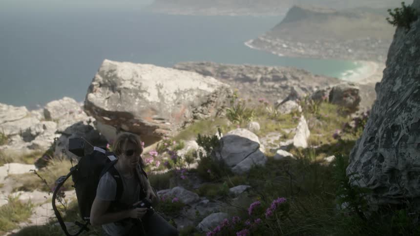 A man is hiking up a mountain