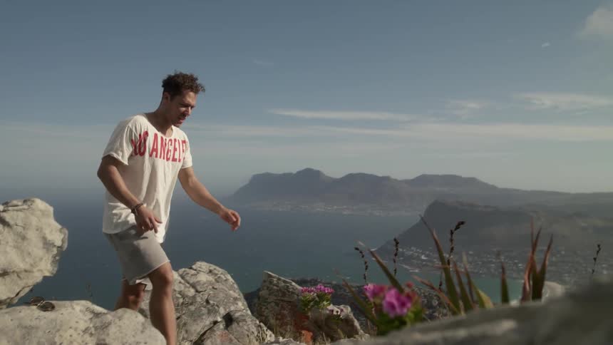 A man jogs up a rocky path
