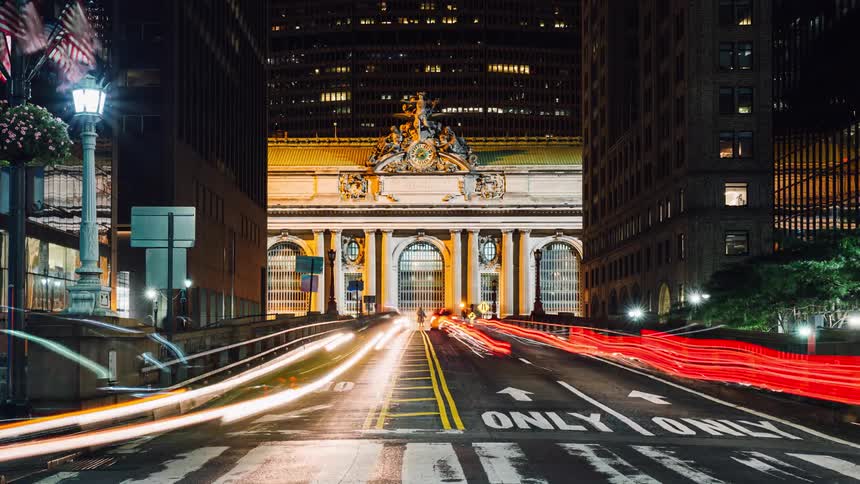 Time lapse of vehicles driving down a city street at night