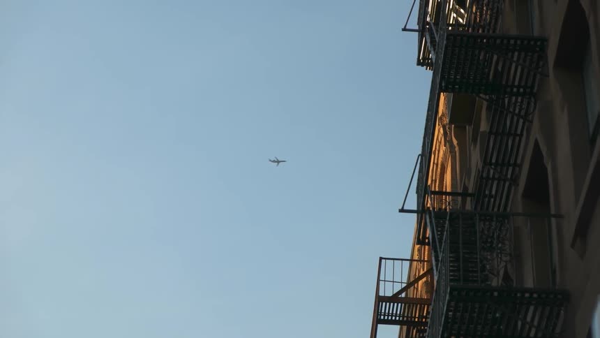 A plane flies in the sky overhead