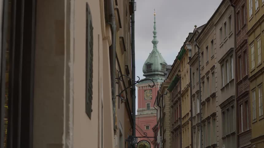 A red building with a blue top stands in the city