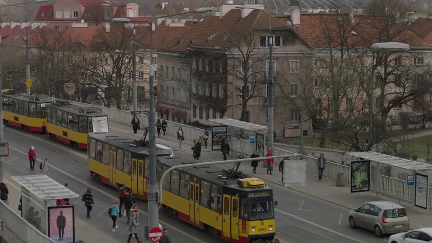 Trolley cars stop to pick up passengers