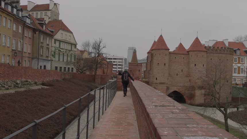 A woman walks outside on an overcast day