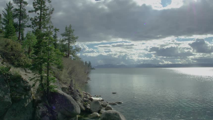 A lake is splashing against the rocky shore aerial