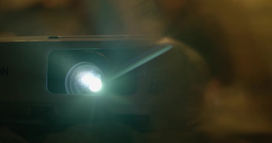 A projector is running in a dark room