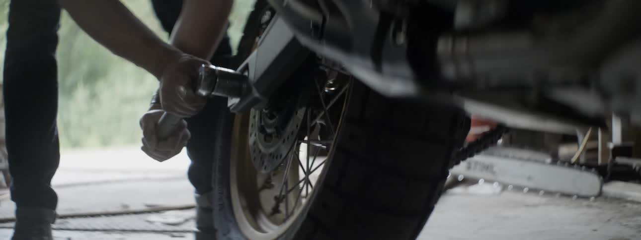 A man is working on his motorcycle