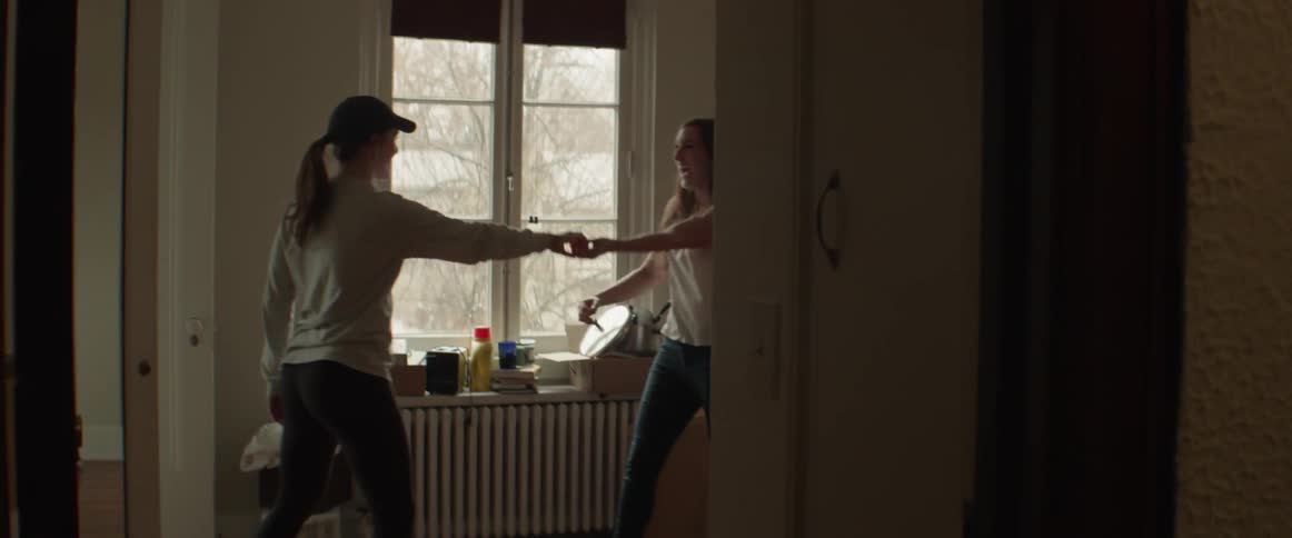 Sisters dance in an apartment