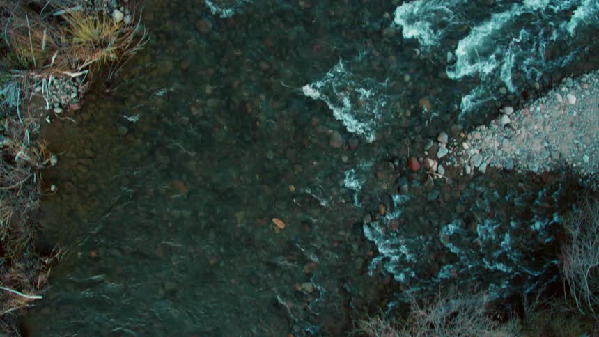 A river flows over a rocky bed