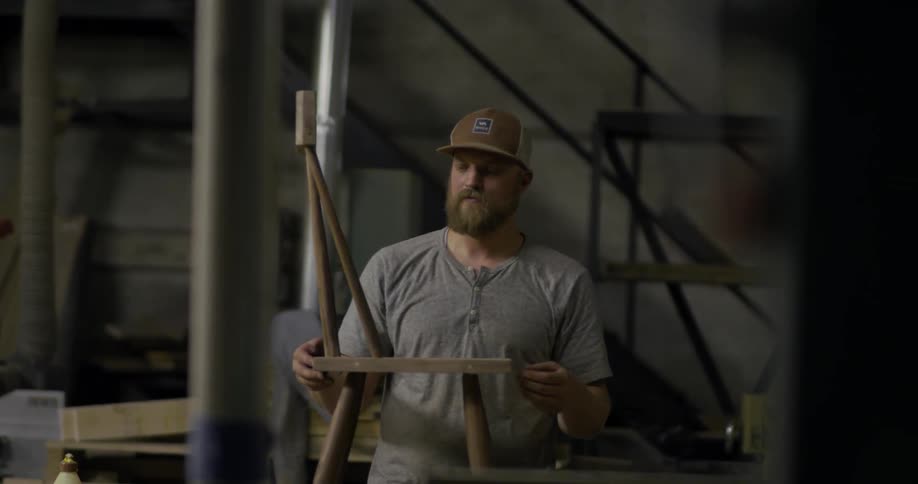 A man lifts a chair and moves it