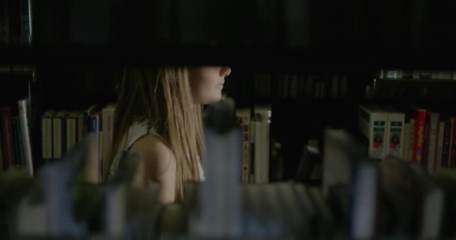 A woman is browsing a library