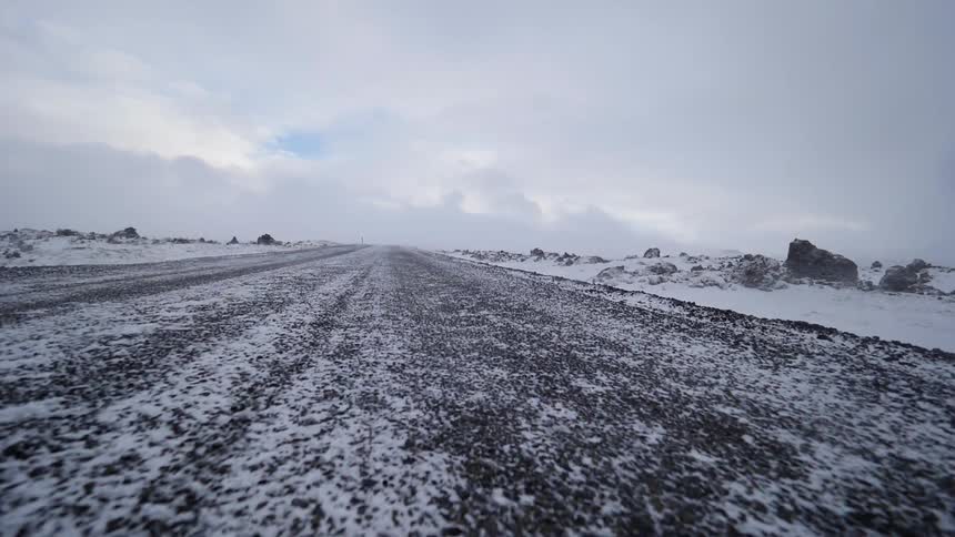 Wind drifts snow across the ground