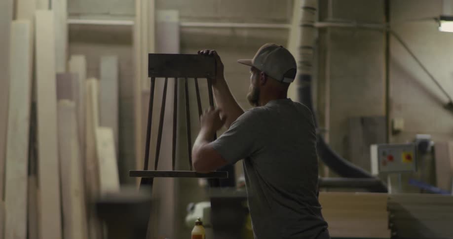 Man builds a chair into a workshop