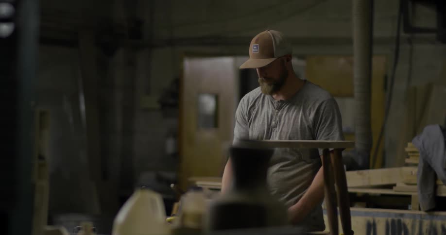 Bearded man using tools in a workshop