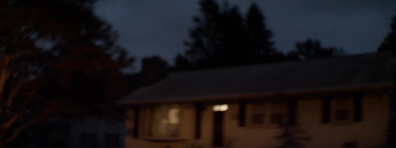 A man rides his motorcycle down the night street