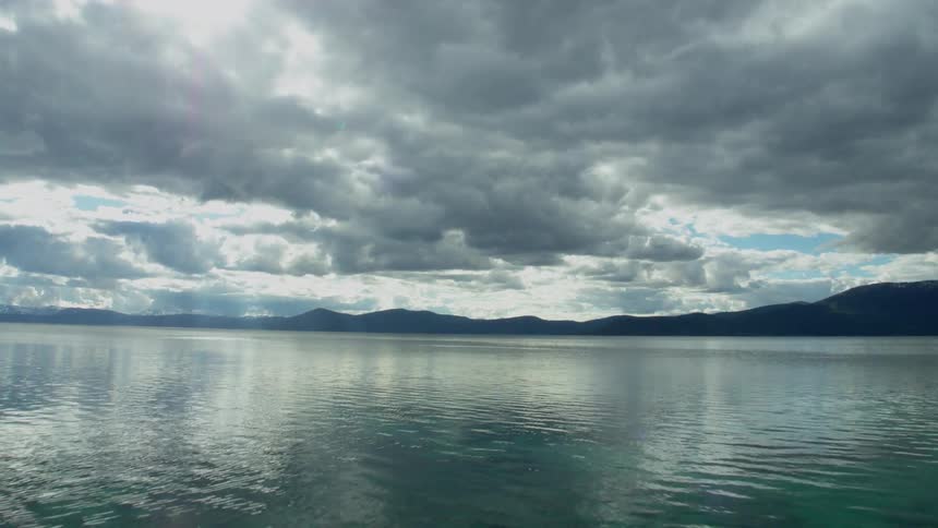 A rippling lake under a cloudy sky