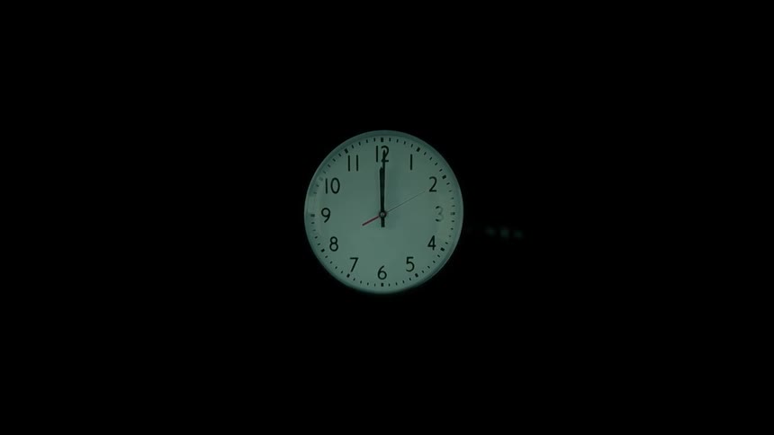 Clock showing midnight against a dark background