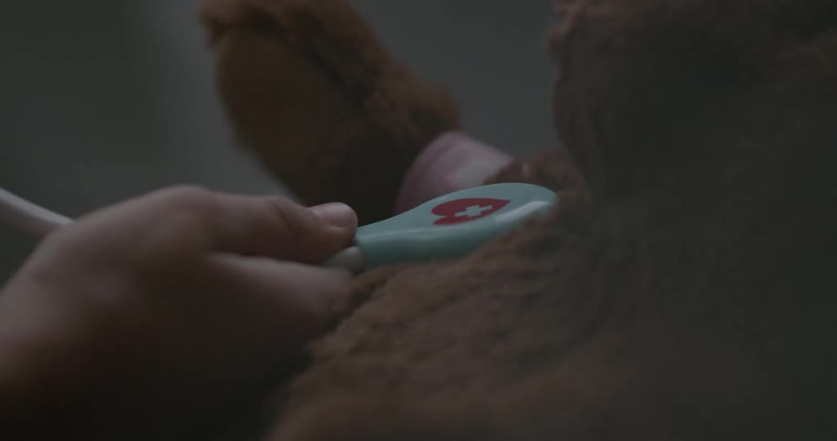 A child uses a toy stethoscope on a teddy bear