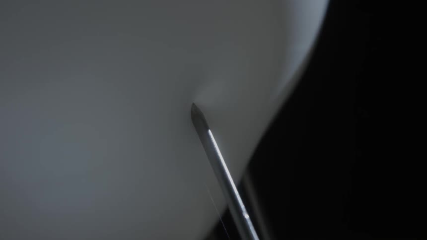 The end of a screwdriver pops a balloon